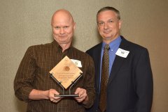 2014 Sunrise Breakfast - Steve Lloyd, left, accepts Syracuse University Sustainable Division's award from Kevin Beverine, right.